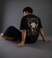 9ELIXIR Ikaros oversized tee — monochrome winged-figure line graphic on black cotton, alternate view