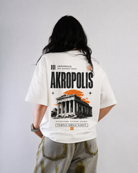 9ELIXIR Akropolis oversized tee — orange temple graphic on cream heavyweight cotton, front